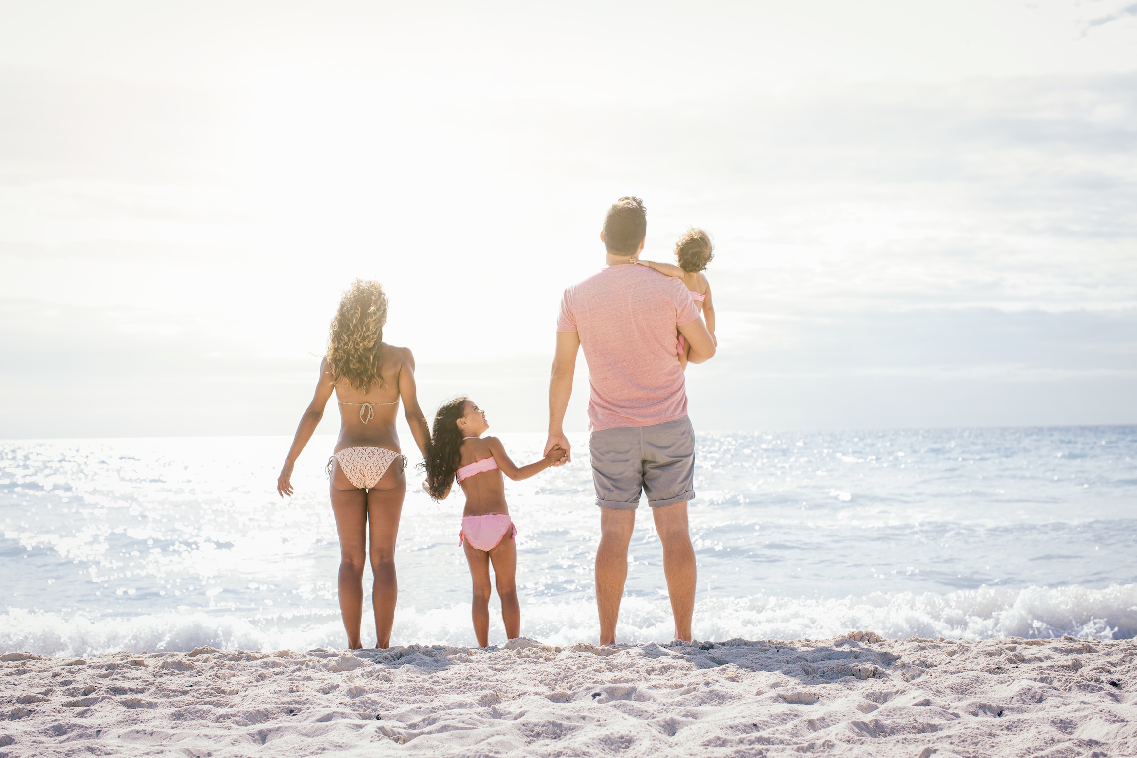 Couple and two girls gazing out to sea, Tuscany, Italy
